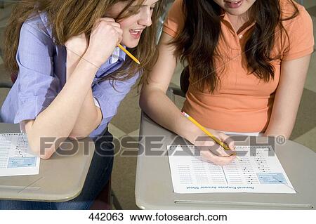 Stock Image - Two students in classroom. Fotosearch
