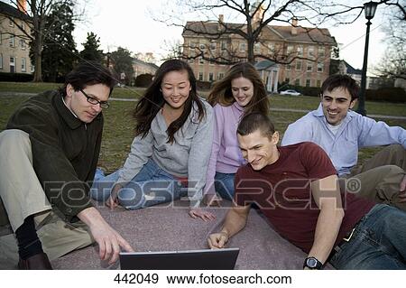 University students sitting on grass with lecturer View Large Photo Image Stock Photo - University students sitting on grass with lecturer. Fotosearch