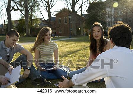 University students sitting on grass with lecturer View Large Photo Image Stock Photograph - University students sitting on grass with lecturer. Fotosearch