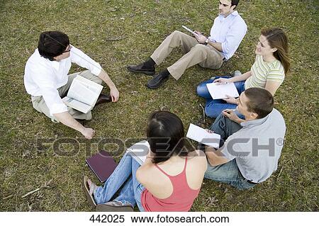 University students sitting on grass with lecturer View Large Photo Image Stock Photography - University students sitting on grass with lecturer. Fotosearch