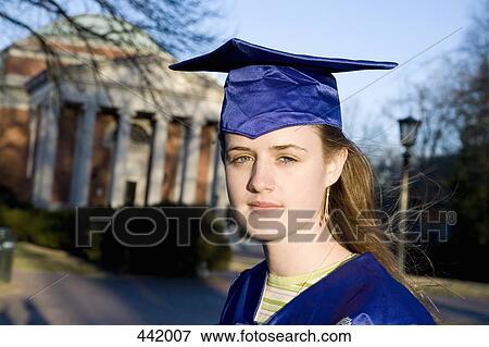 Woman in a graduation gown and mortar board outside of university View Large Photo Image Stock Photo - Woman in a graduation gown and mortar board outside of university. Fotosearch