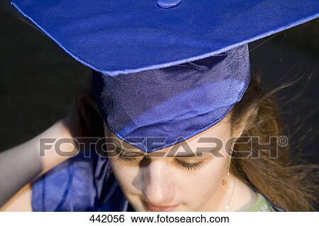 Woman in a graduation gown and mortar board outside of university View Large Photo Image Stock Photograph - Woman in a graduation gown and mortar board outside of university. Fotosearch