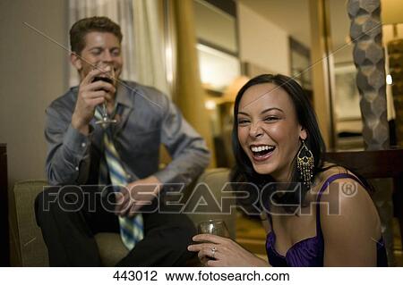 Young couple laughing together in a hotel room View Large Photo Image Stock Image - Young couple laughing together in a hotel room. Fotosearch