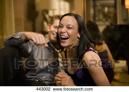 Young woman pulling a man's tie and laughing View Large Photo Image Stock Image - Young woman pulling a man's tie and laughing. Fotosearch