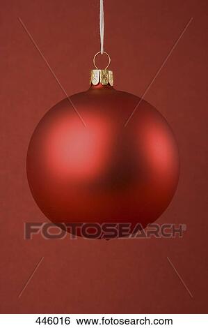 Stock Photograph - A red Christmas bauble. Fotosearch