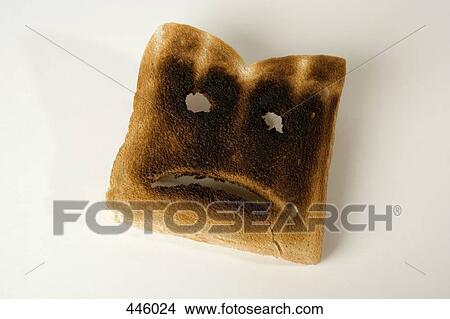 A slice of burnt toast with a sad face View Large Photo Image Picture - A slice of burnt toast with a sad face. Fotosearch