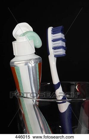 Stock Photography - Toothpaste and toothbrush in a glass. Fotosearch