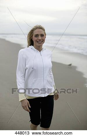 A woman standing on a beach View Large Photo Image Stock Image - A woman standing on a beach. Fotosearch