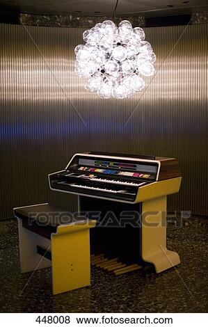 Designer light fitting above a vintage organ View Large Photo Image Stock Photo - Designer light fitting above a vintage organ. Fotosearch