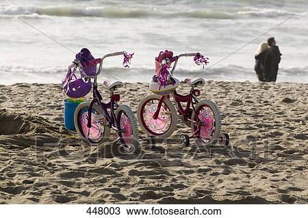 Two girl's bicycles side by side on a beach View Large Photo Image Stock Image - Two girl's bicycles side by side on a beach. Fotosearch