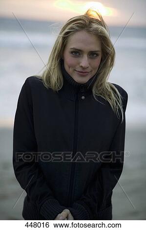 Woman standing on a beach with hands clasped View Large Photo Image Stock Photograph - Woman standing on a beach with hands clasped. Fotosearch