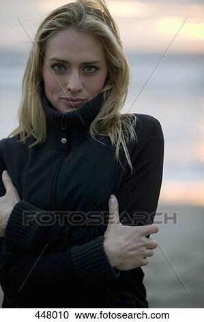 Woman standing with arms crossed on a beach View Large Photo Image Stock Image - Woman standing with arms crossed on a beach. Fotosearch