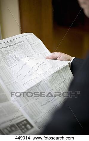 Picture - Businessman reading a newspaper. Fotosearch