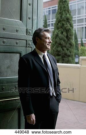 Businessman standing in a doorway View Large Photo Image Stock Photo - Businessman standing in a doorway. Fotosearch