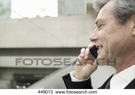 Businessman using a mobile phone View Large Photo Image Stock Image - Businessman using a mobile phone. Fotosearch