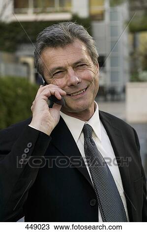 Businessman using a mobile phone View Large Photo Image Stock Image - Businessman using a mobile phone. Fotosearch