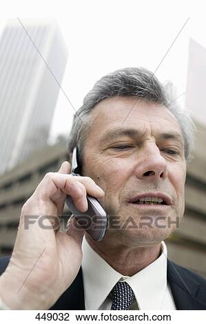 Businessman using a mobile phone View Large Photo Image Stock Image - Businessman using a mobile phone. Fotosearch