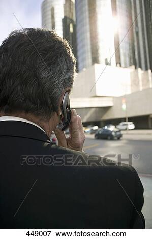 Businessman using a mobile phone View Large Photo Image Stock Photo - Businessman using a mobile phone. Fotosearch