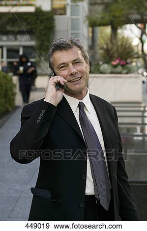 Businessman using a mobile phone View Large Photo Image Stock Photo - Businessman using a mobile phone. Fotosearch