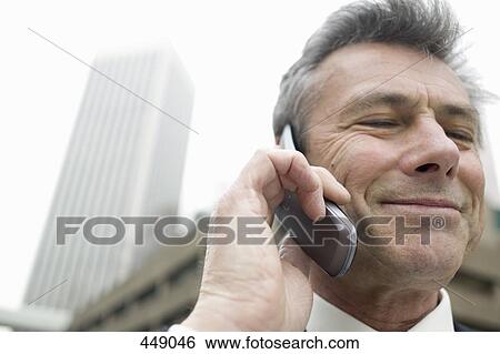 Stock Photograph - Businessman using a mobile phone. Fotosearch