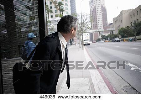 Businessman waiting for a bus View Large Photo Image Stock Photograph - Businessman waiting for a bus. Fotosearch