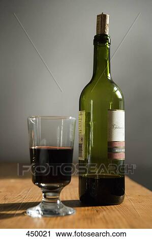 Stock Image - A bottle of red wine and a glass. Fotosearch