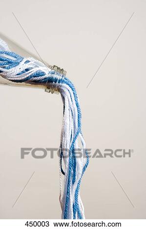 Blue and white wool pouring from a bottle View Large Photo Image Stock Image - Blue and white wool pouring from a bottle. Fotosearch