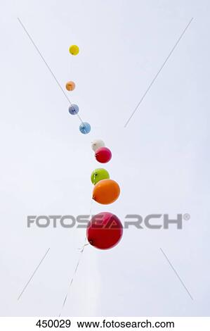 Helium balloons tied to a string View Large Photo Image Stock Photo - Helium balloons tied to a string. Fotosearch