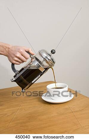 Stock Image - Pouring coffee from a cafetiere. Fotosearch