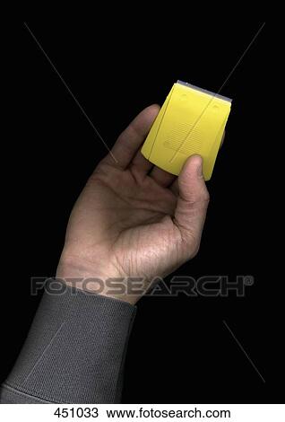 Stock Image - Man holding a plastic scraper. Fotosearch