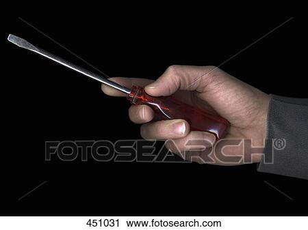 Stock Image - Man holding a screwdriver. Fotosearch