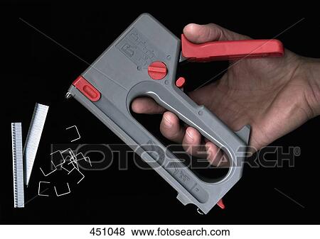Man holding a staple gun View Large Photo Image Stock Photo - Man holding a staple gun. Fotosearch