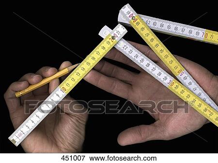 Man using a folding ruler and a pencil View Large Photo Image Stock Photo - Man using a folding ruler and a pencil. Fotosearch