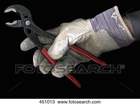Man wearing a work glove and holding a pair of pliers View Large Photo Image Stock Image - Man wearing a work glove and holding a pair of pliers. Fotosearch