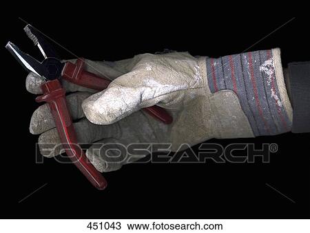 Man wearing a work glove and holding a pair of pliers View Large Photo Image Stock Image - Man wearing a work glove and holding a pair of pliers. Fotosearch