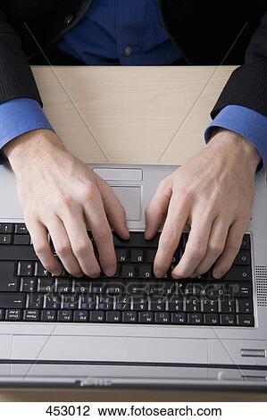 Businessman typing on a laptop View Large Photo Image Stock Image - Businessman typing on a laptop. Fotosearch