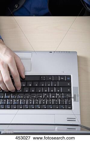 Close-up of a businessman typing on a laptop View Large Photo Image Stock Photo - Close-up of a businessman typing on a laptop. Fotosearch