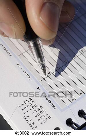 Close-up of a man with a pen and personal organizer View Large Photo Image Stock Image - Close-up of a man with a pen and personal organizer. Fotosearch