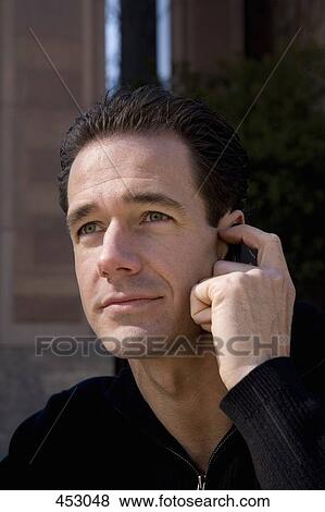 Man using a mobile phone View Large Photo Image Stock Photo - Man using a mobile phone. Fotosearch