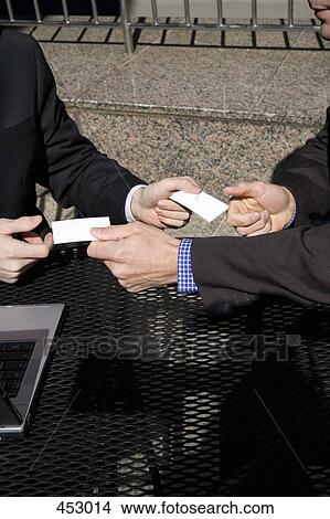Two men exchanging business cards View Large Photo Image Picture - Two men exchanging business cards. Fotosearch