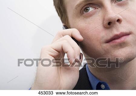 Young businessman using a mobile phone View Large Photo Image Stock Image - Young businessman using a mobile phone. Fotosearch