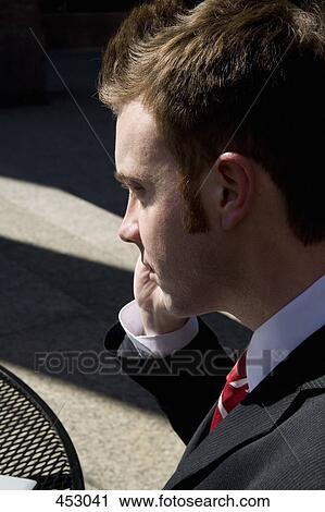 Young businessman using a mobile phone View Large Photo Image Stock Image - Young businessman using a mobile phone. Fotosearch