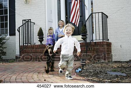 A mother in front of a house with her family View Large Photo Image Stock Photo - A mother in front of a house with her family. Fotosearch