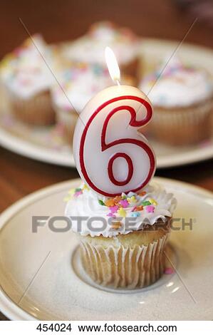 Decorated cupcake with a lit candle View Large Photo Image Picture - Decorated cupcake with a lit candle. Fotosearch