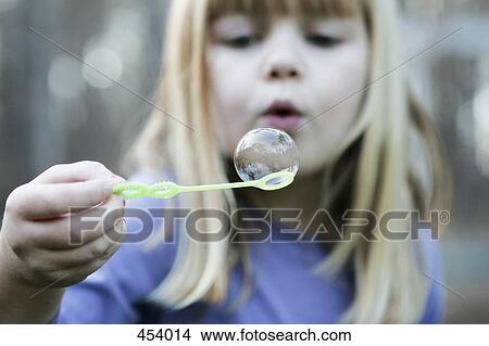 Young girl blowing a bubble View Large Photo Image Picture - Young girl blowing a bubble. Fotosearch
