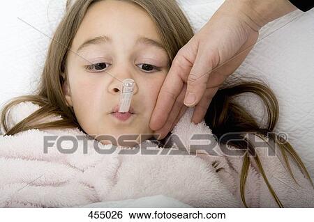 A girl lying in bed unwell View Large Photo Image Stock Photograph - A girl lying in bed unwell. Fotosearch