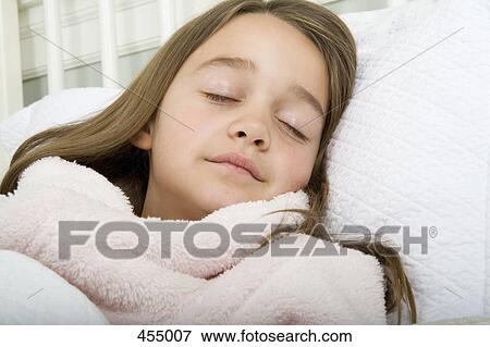 A girl sleeping in bed View Large Photo Image Stock Photo - A girl sleeping in bed. Fotosearch