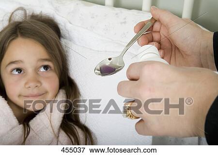 A mother giving unwell daughter medicine View Large Photo Image Stock Photo - A mother giving unwell daughter medicine. Fotosearch
