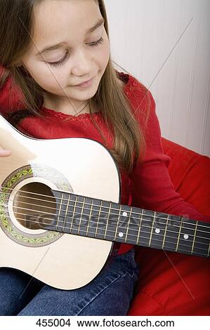 Young girl practicing guitar View Large Photo Image Picture - Young girl practicing guitar. Fotosearch