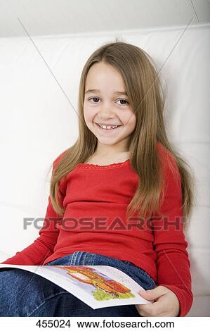 Young girl reading a book View Large Photo Image Picture - Young girl reading a book. Fotosearch